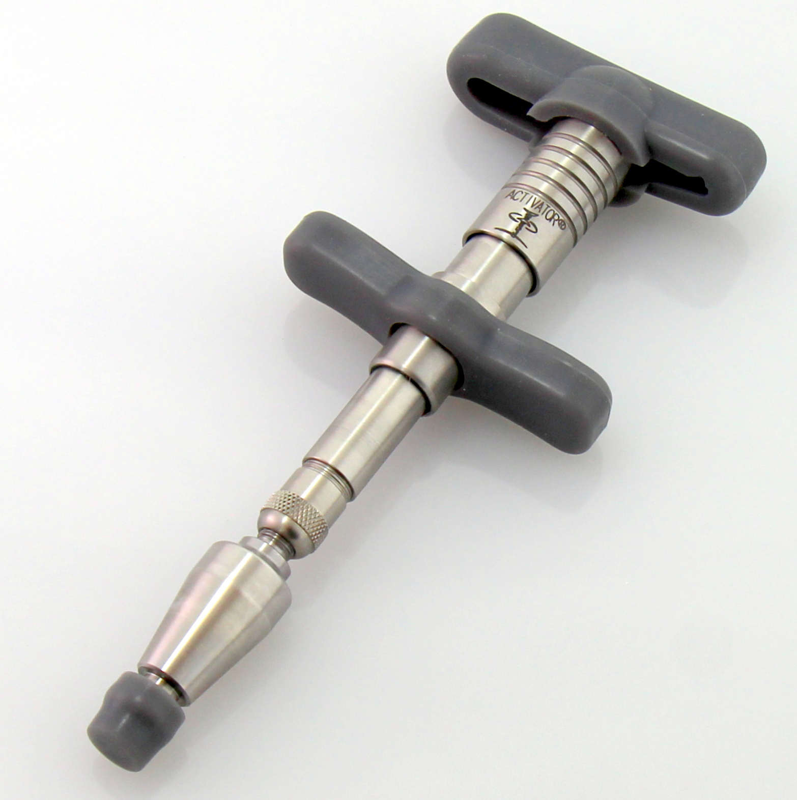 The Activator, a small stainless steel handheld instrument used to deliver a precise low-force chiropractic impulse.